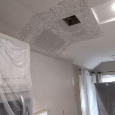 Water damage in house ceiling with visible stains and discoloration caused by leaks. Associated musty smell indicates potential mold growth.