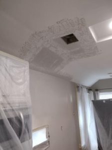 Water damage in house ceiling with visible stains and discoloration caused by leaks. Associated musty smell indicates potential mold growth.