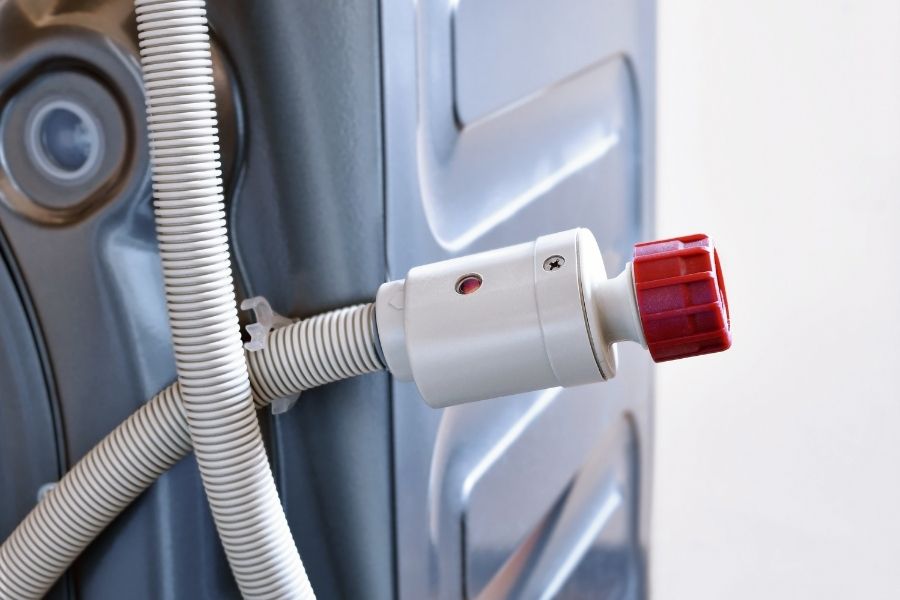 Washing machine hoses being inspected for wear and damage